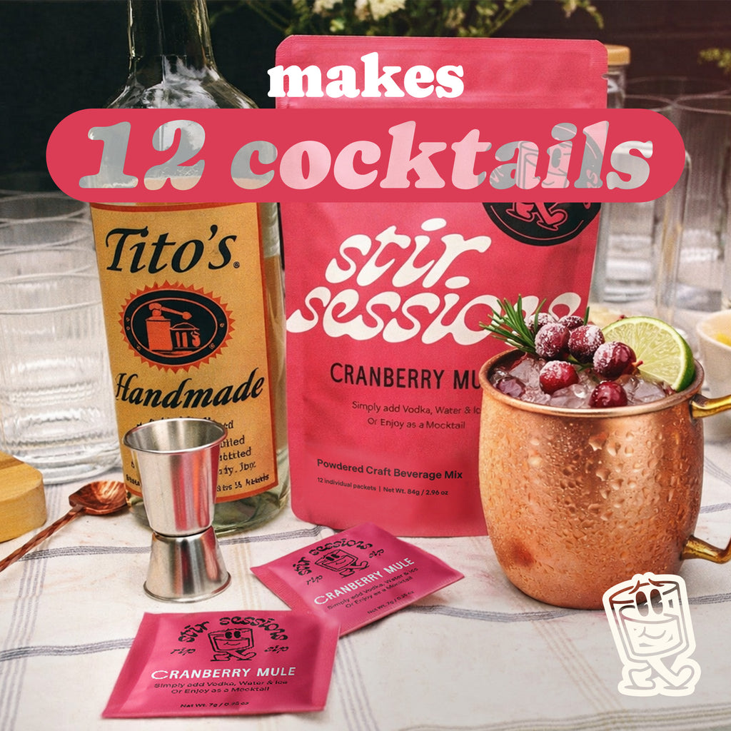 Stir Sessions Cranberry Mule powdered cocktail or mocktail drink making kit with Tito's Handmade Vodka and mix packets on a table.
