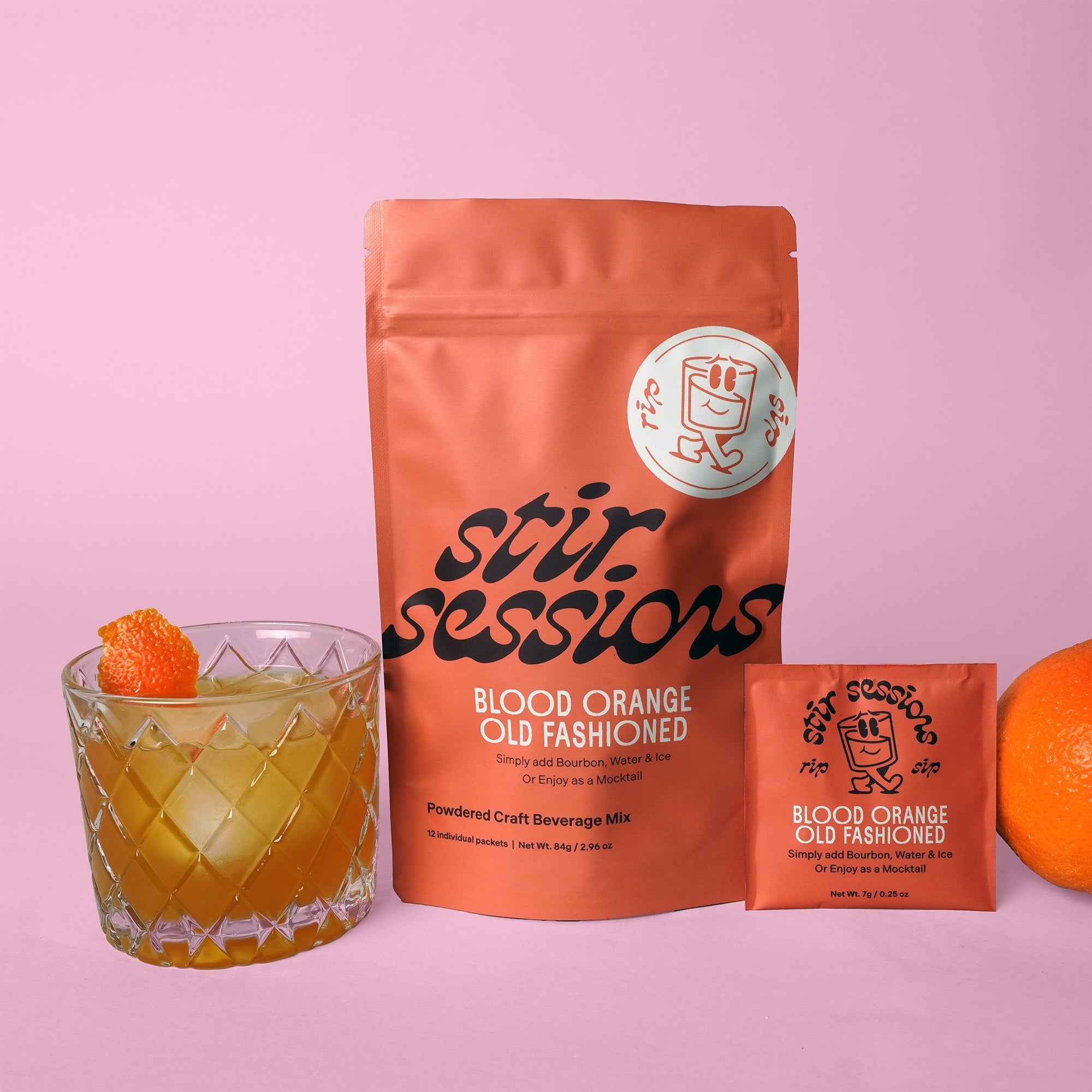 Stir Sessions Blood Orange Old Fashioned drink mix package with a cocktail and orange on a pink background