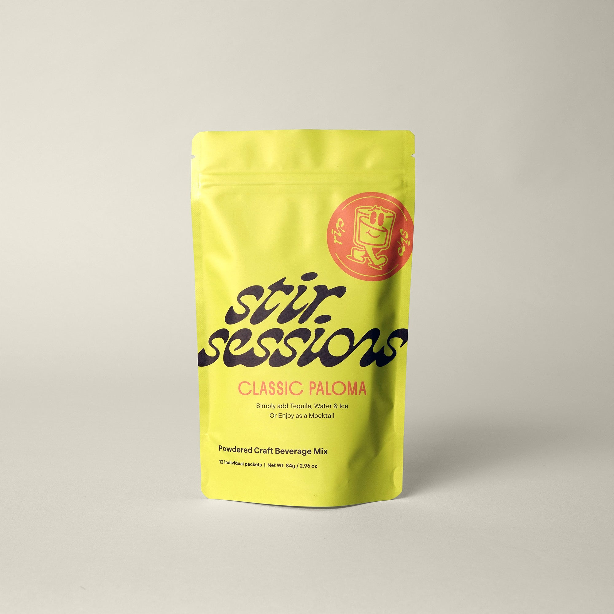 Yellow package of 'Stir Sessions Classic Paloma' beverage mix on a light gray background
