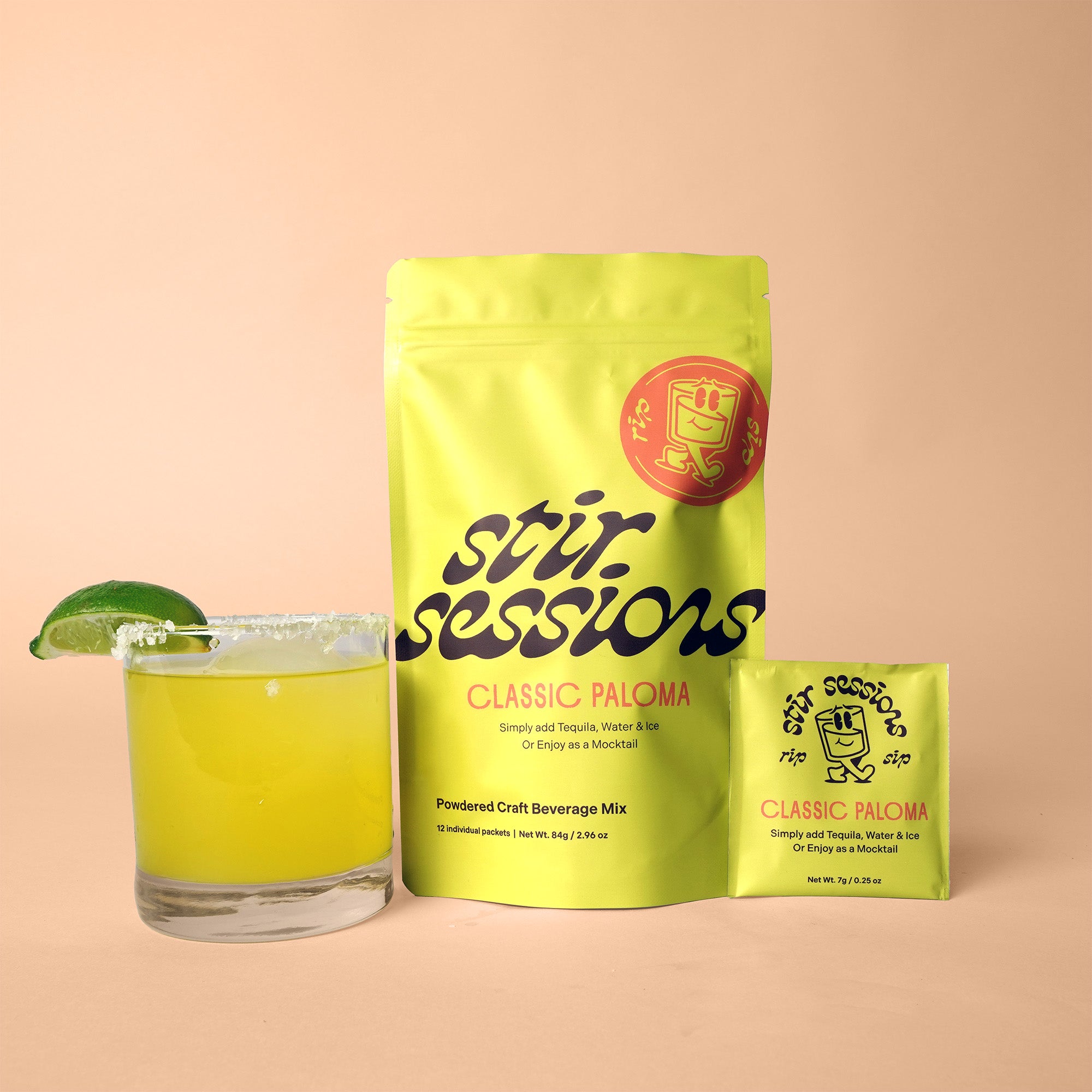 Stir Sessions Classic Paloma grapefruit beverage mix package with a glass of lime-sliced drink on a peach background
