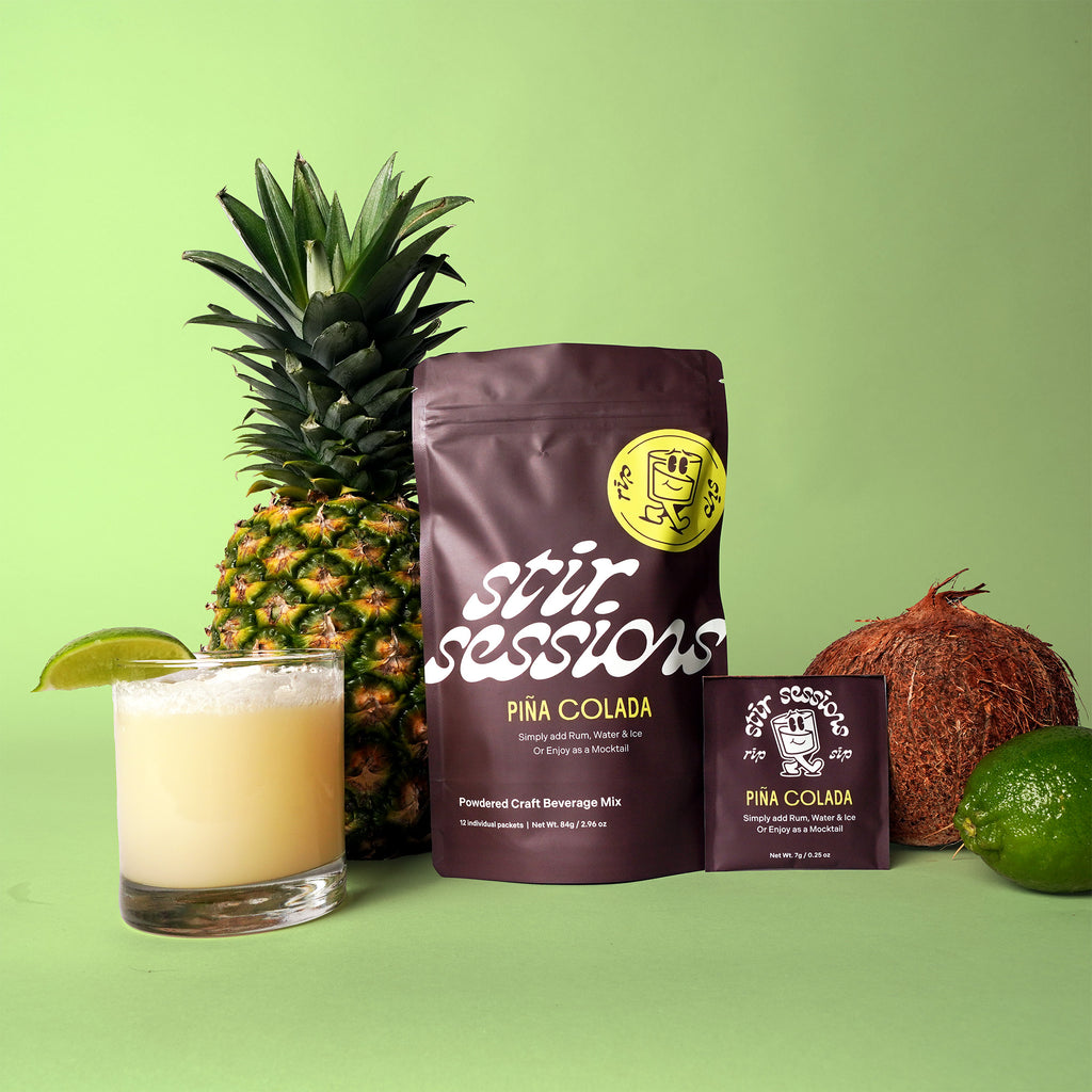 Stir Sessions Pina Colada powdered cocktail or mocktail drink beverage packaging drink mix with a pineapple, coconut, lime, and glass of drink on a green background