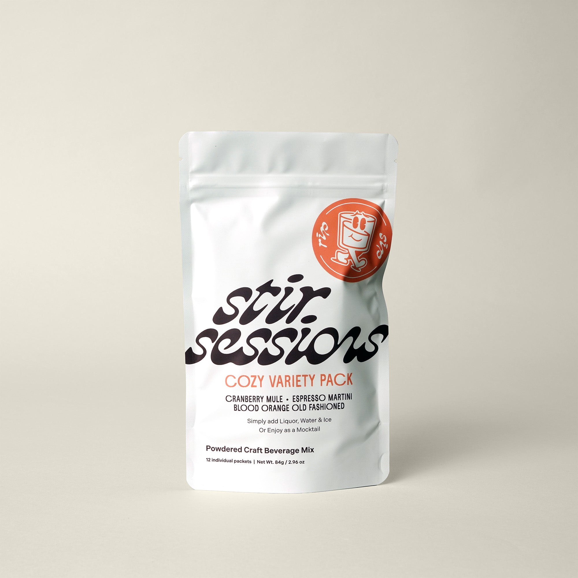 Stir Sessions Cozy Variety Pack of powdered craft cocktail or mocktail beverage mixers packaging on a beige background, front view.