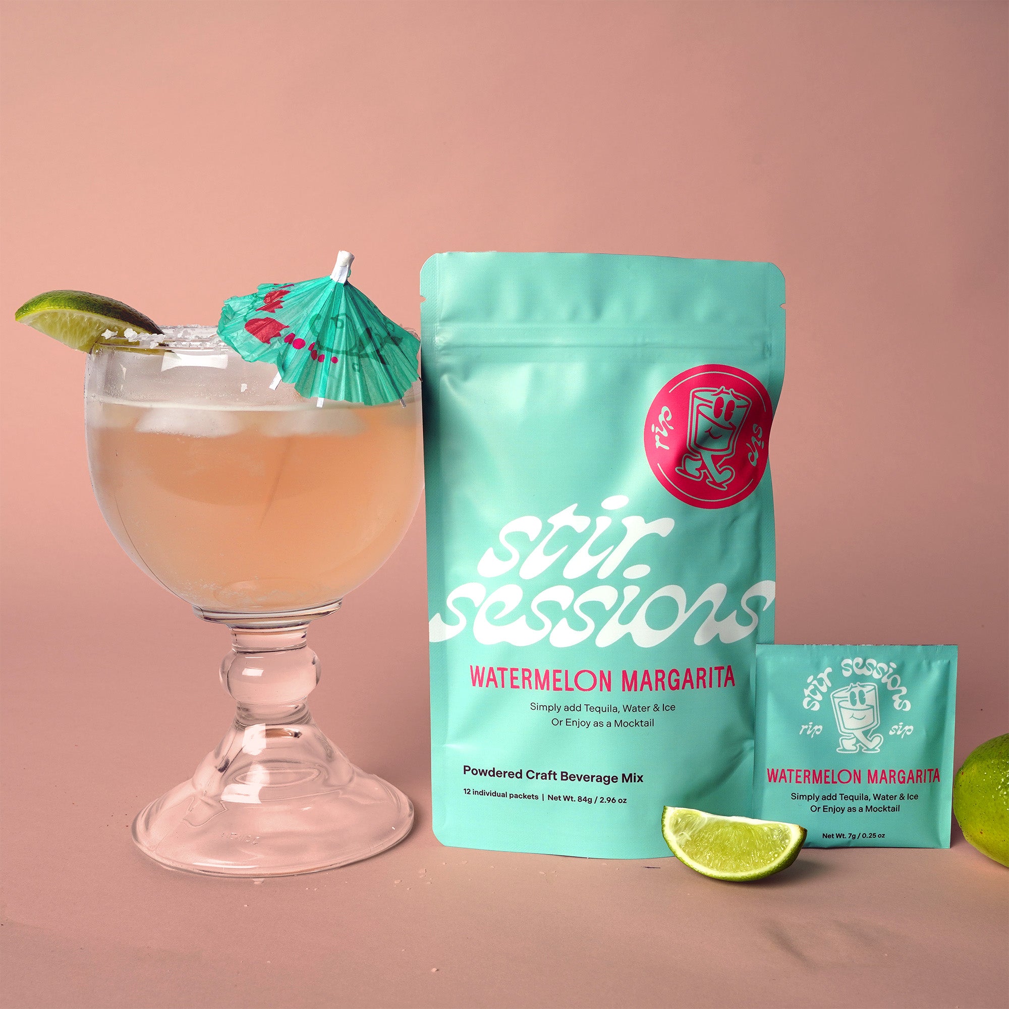 Stir Sessions Watermelon Margarita mix with a cocktail and lime wedges on a pink background