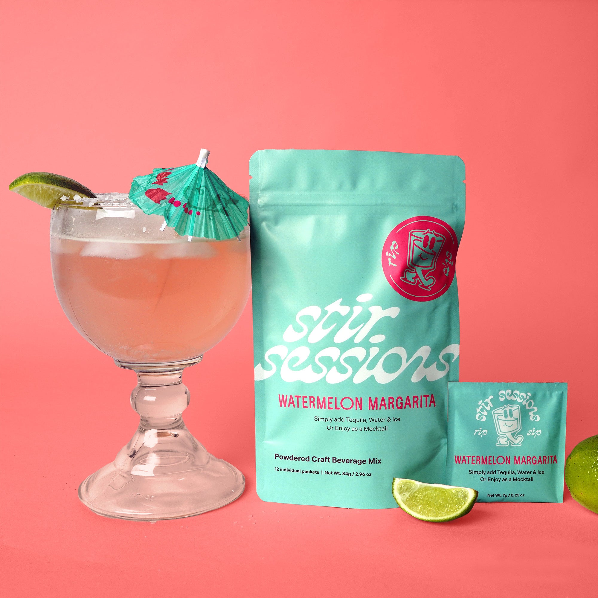 Stir Sessions Watermelon Margarita mix with a cocktail and lime wedges on a pink background